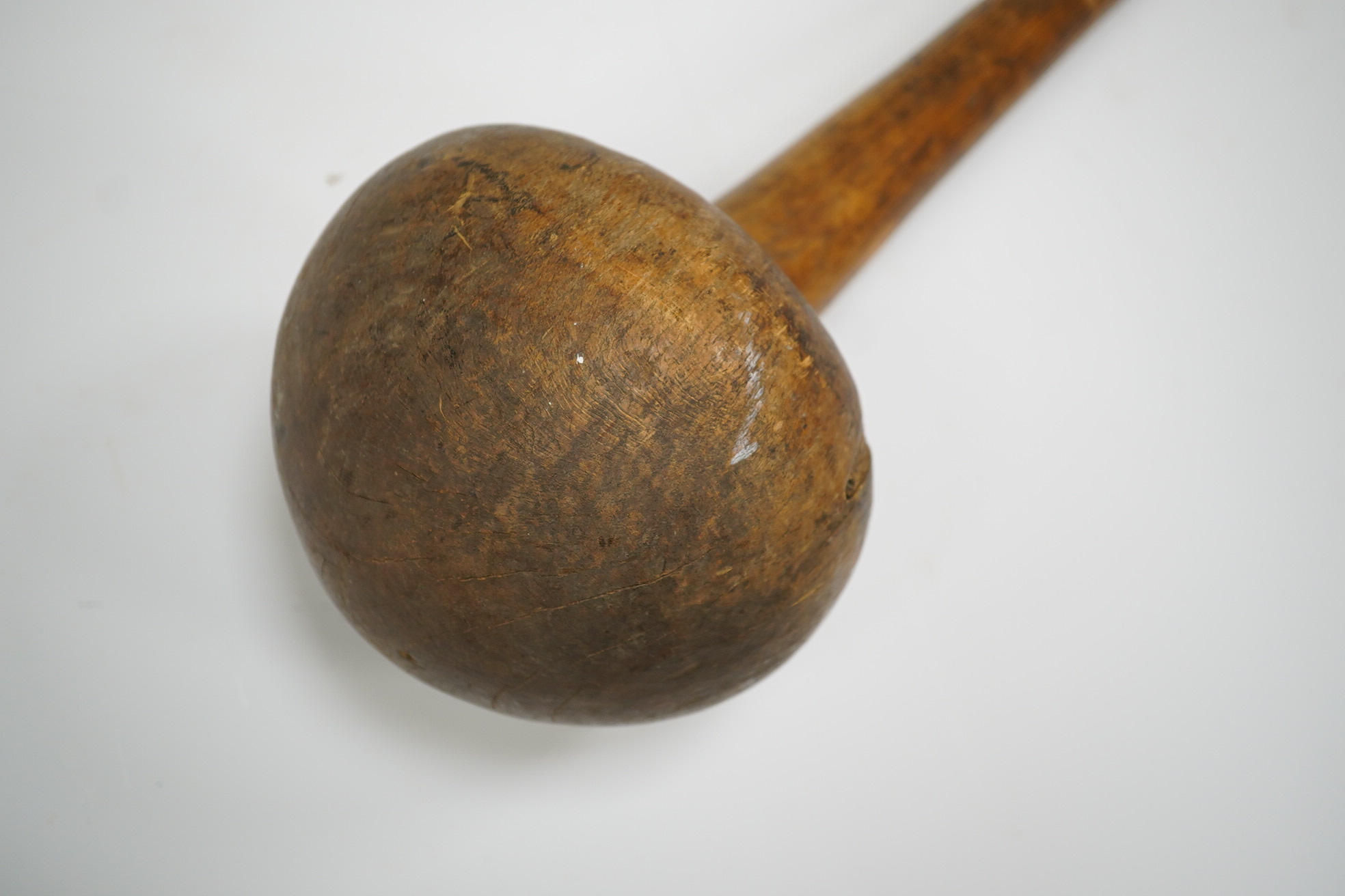 A Sudanese wooden Knobkerrie, approximately 62cm long, with profoundly swollen mushroom shaped head. Condition - poor to fair